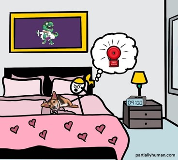 Girl lying in bed with a dog on top of her, frightened and a fire alarm going off